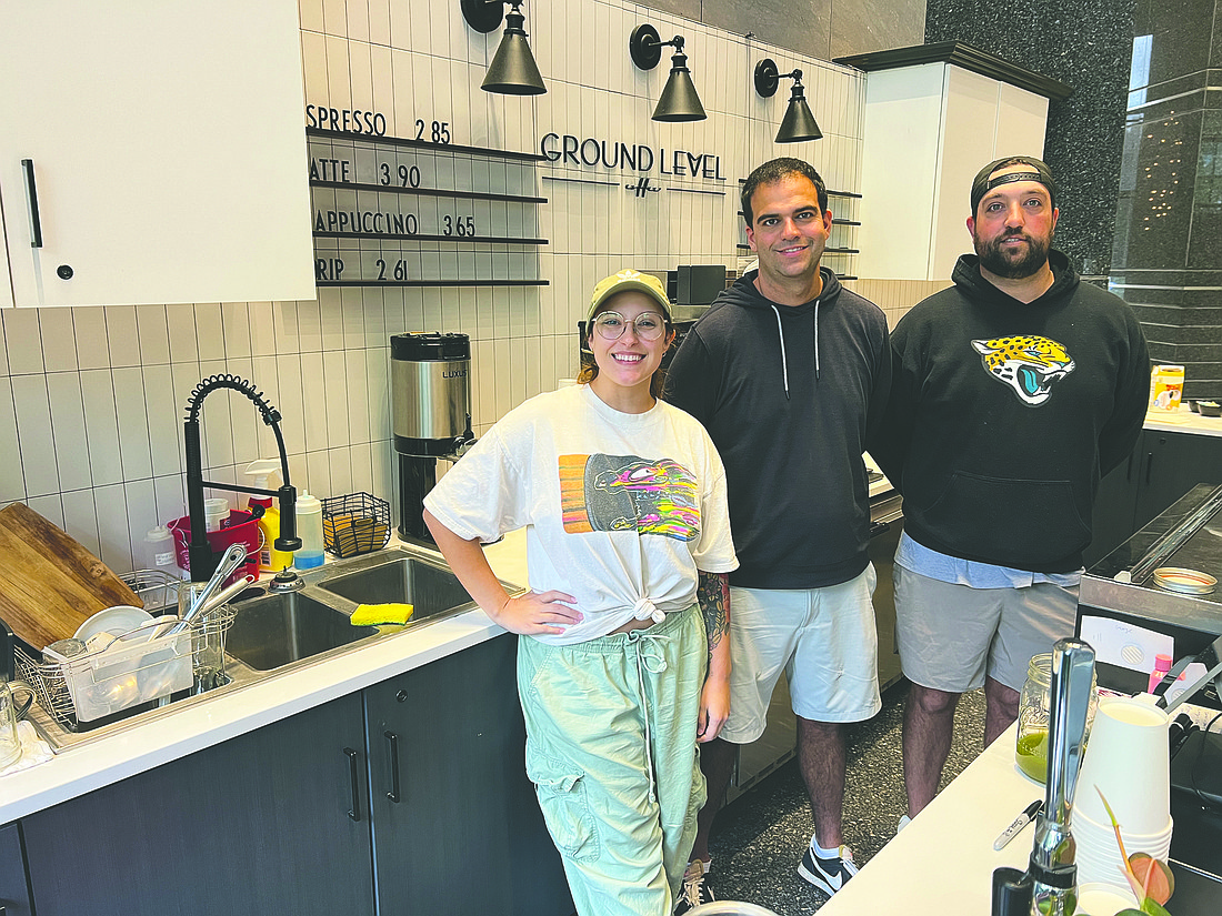 Lexi Burkley, barista at Ground Level, with owners of Akel's Deli Matthew and Jonathan Bateh.