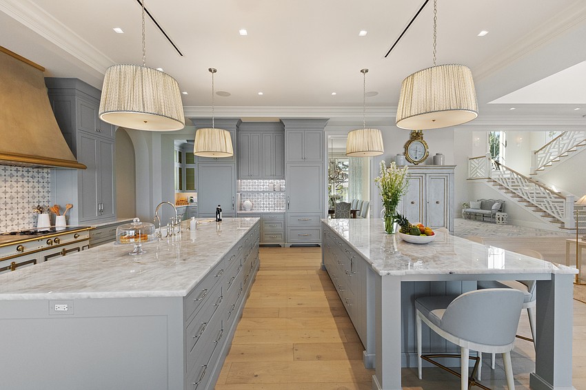 Two islands in the kitchen at Crystal Waters provide ample food preparation and gathering space.