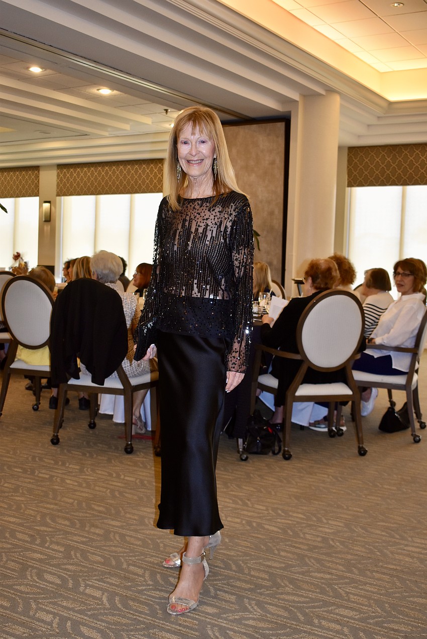 Eileen Hackler models a black sequined top and satin skirt.