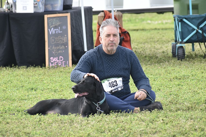 Tony Funk enjoys the grass with his dog Princess.