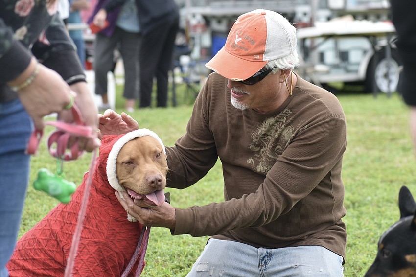 Penny gets her Santa Claus costume adjusted by her dad Roger Landry.