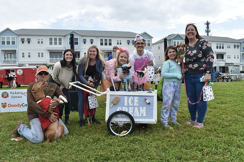 Roger Landry and his dog Penny, Sophie Camp of costume contest sponsor Comfort Suites Sarasota, Heiden Riegel and her dog River, Madi Sparks and Ocean Wolf and their dogs Buster and Pepper, and Georjann and Erica Danke and their dog Phoebe.