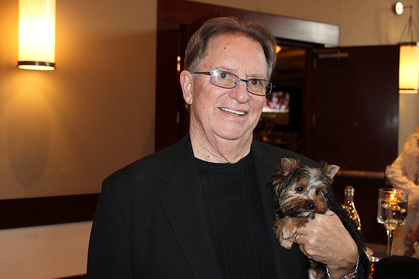 John Fain holds the doggy that was to be auctioned at All That Jazz: Cabaret for a Cause.