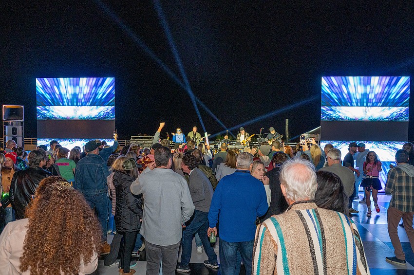 The crowd dances to the band Mid Life Crisis.