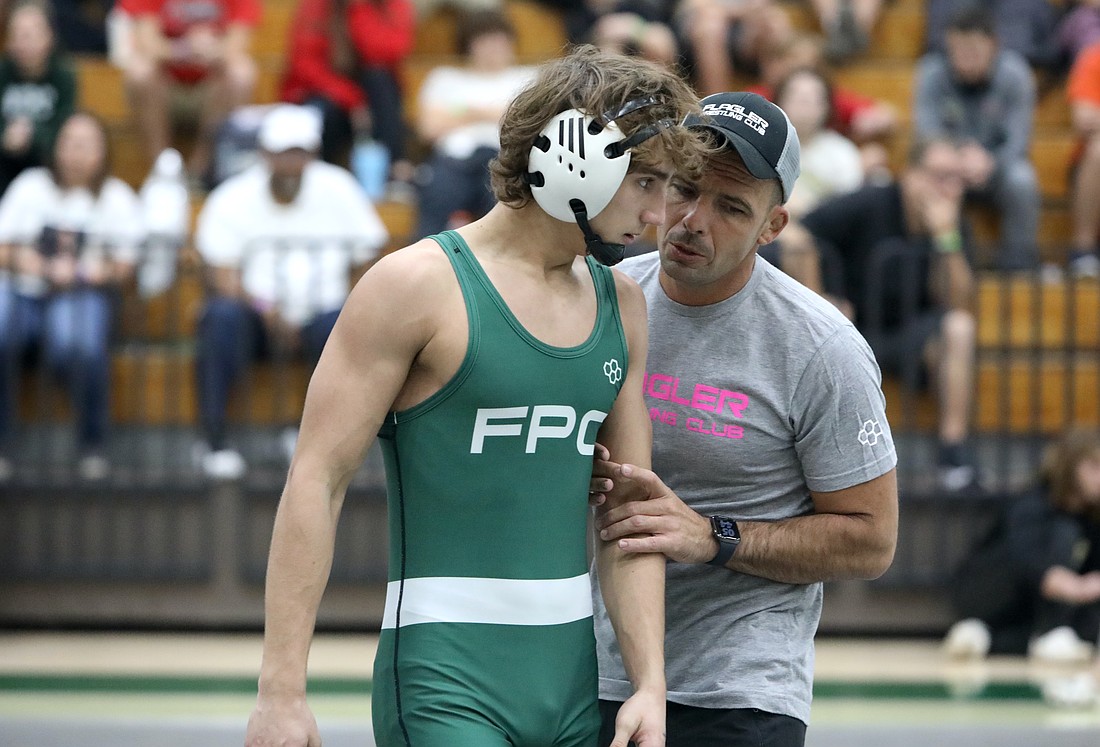 FPC senior Carson Baert, here conferring with coach David Bossardet at the 2024 Flagler Rotary tournament, won his first district championship on Feb. 20 at Gainesville Buchholz High School. File photo by Brent Woronoff