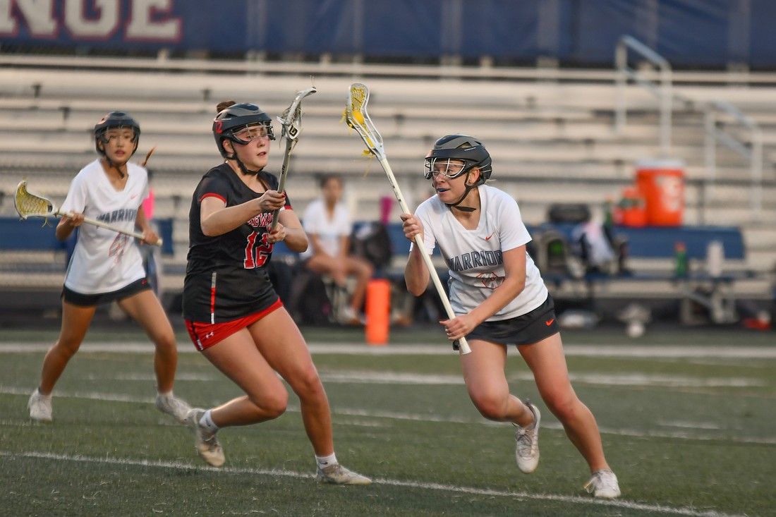 West Orange junior Addison Petch (No. 8) drove past the Edgewater High defender.