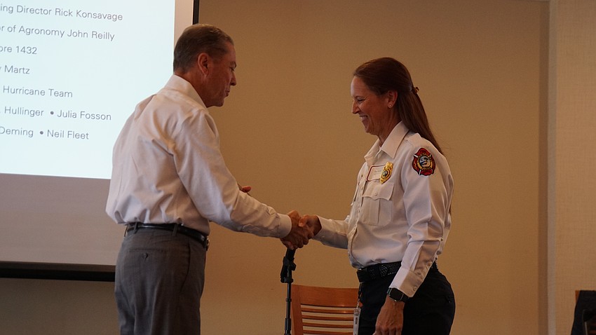 Public Information Officer Tina Adams was honored at the award ceremony, where she accepted an award from H. Joseph Reiser.