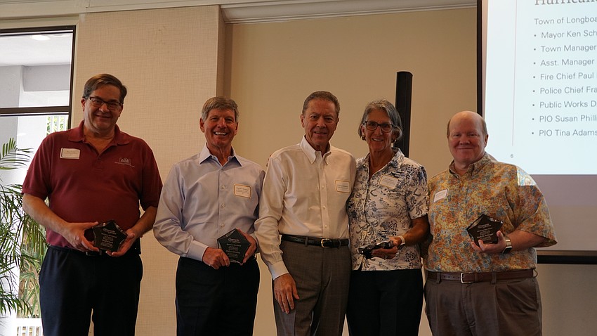 Members of the Bay Isles Association Neil Fleet, Philip Deming, Julia Fosson and Mark Hullinger accept awards from the president of the association H. Joseph Reiser (center).