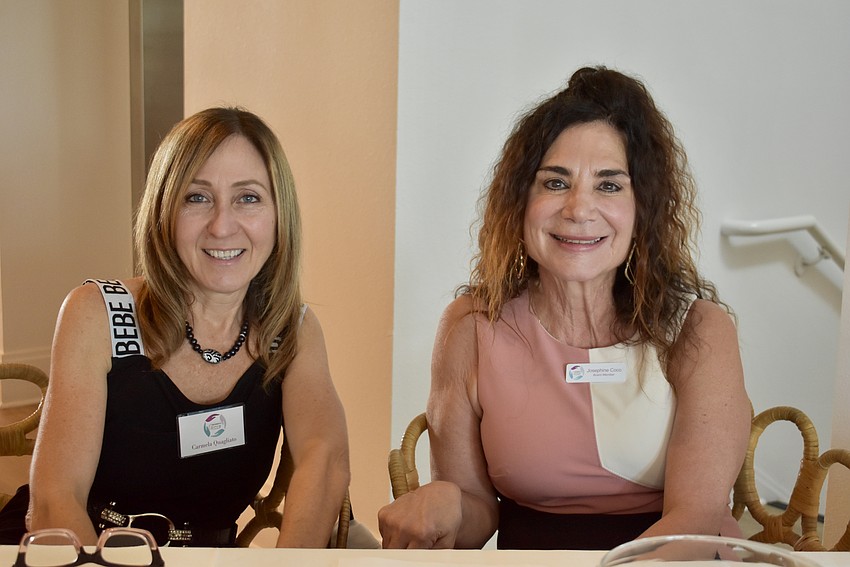 Club members Carmela Quagliato and Josephine Coco are the welcoming committee, handing out name tags.