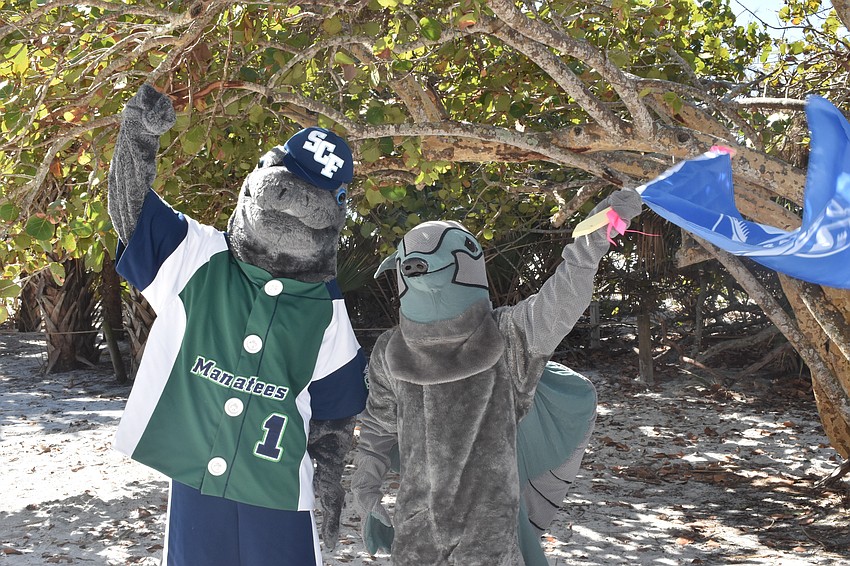 Maverick the Manatee from State College of Florida poses with Remy the armadillo from Ringling College of Art & Design.