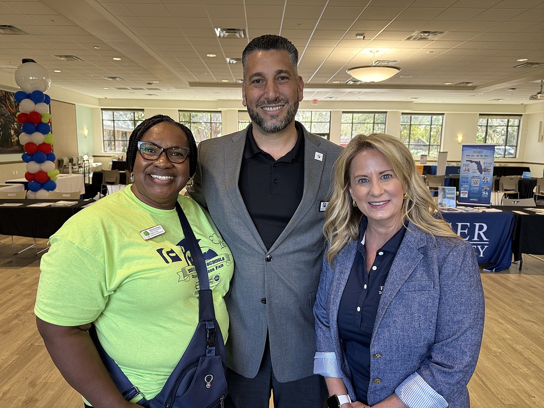 Flagler County Education Foundation Executive Director Teresa Rizzo (right) and Assistant Director of Finance and Operations Maryiotti Johnson (left) with Flagler Schools Director of Student Services John Fanelli at the College and Career Fair. Photo by Brian McMillan