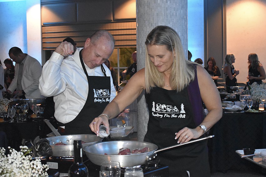 Patrick Foster and his wife, Southside Elementary Principal Allison Foster, cook some steak.