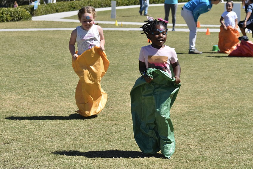 Everleigh Jaworski, 5 and Soraya Love, 3, participate in a potato sack race themed around nature.