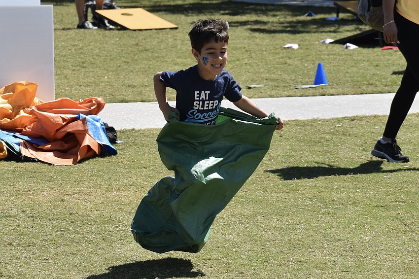 Noah Panica, 4, participates in the potato sack race.