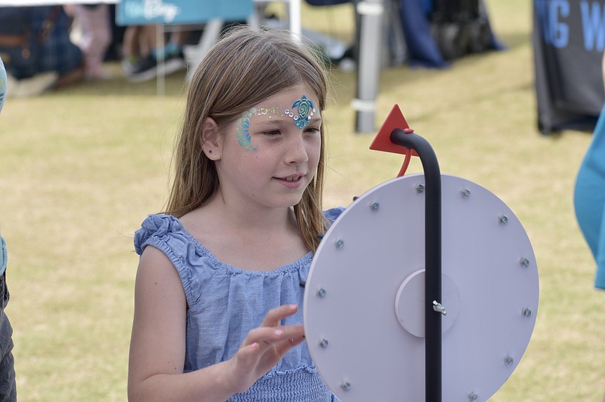 Saylor Johnson, 8, performs a wheel-spinning activity.