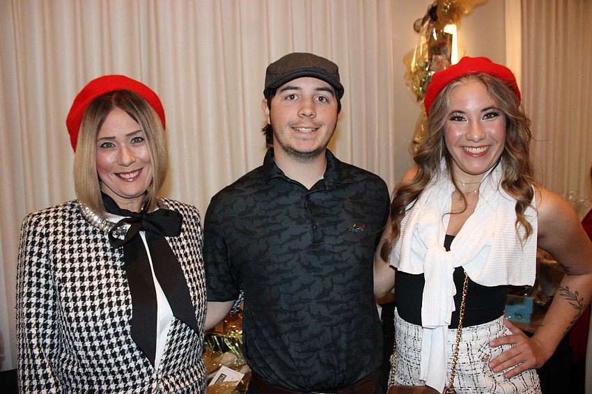 Ellenton's Lynn Turner, Andrew Rhoden, and Sophia Warmbier came to support Meals on Wheels Plus at Tropical Nights Under Paris Lights Saturday at the 
Grove.