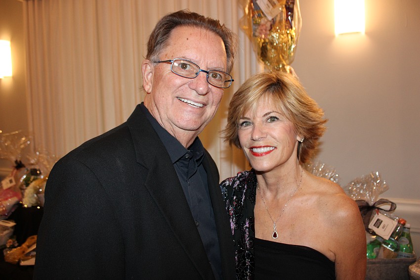 Lakewood Ranch's John Fain and Angela Massaro Fain are all smiles at Tropical Nights Under Paris Lights at the Grove in Lakewood Ranch Saturday.