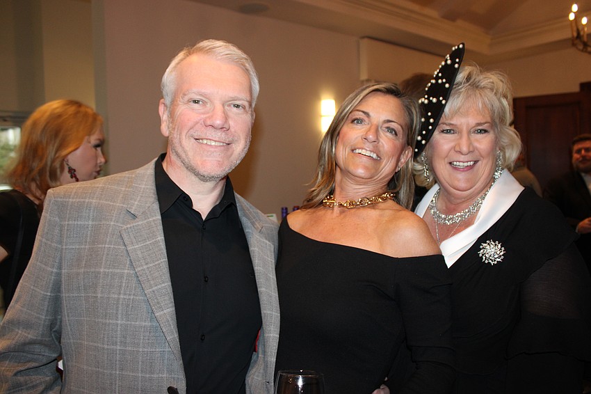 Darrell and Hilarie King share a laugh with Meals on Wheels President and CEO Maribeth Phillips during Tropical Nights.