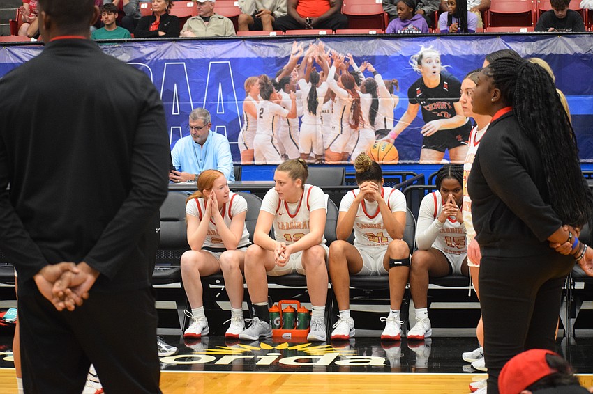 Members of the Cardinal Mooney girls basketball take time to collect themselves before being announced just prior to tip-off against Bolles in the 3A state championship game.