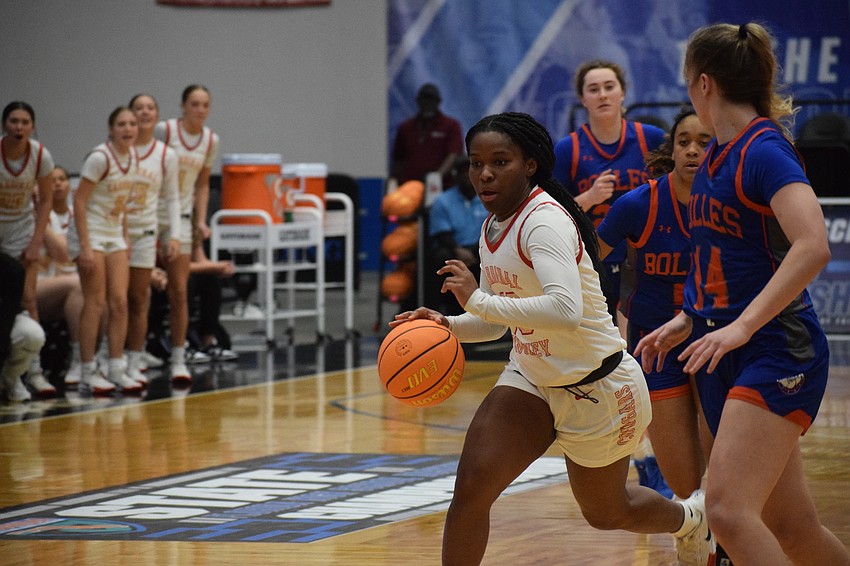 Cardinal Mooney senior guard Sy'monique Williams drives against Bolles guard Abby Knauff in the 3A state championship game at RP Funding Center in Lakeland.