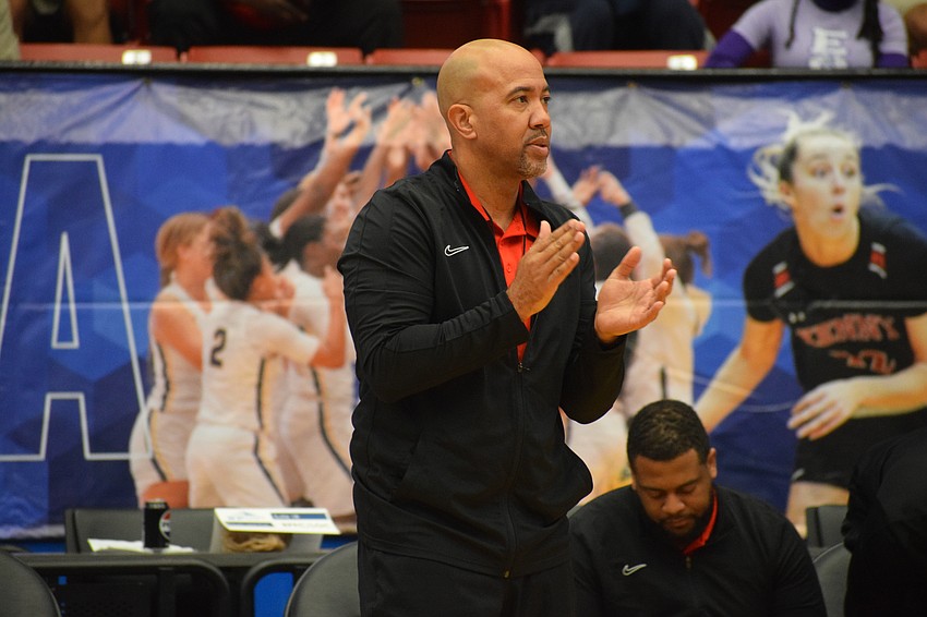 Cardinal Mooney girls basketball coach Marlon Williams claps for his team during the 3A state championship game against Bolles on March 1 at RP Funding Center in Lakeland.