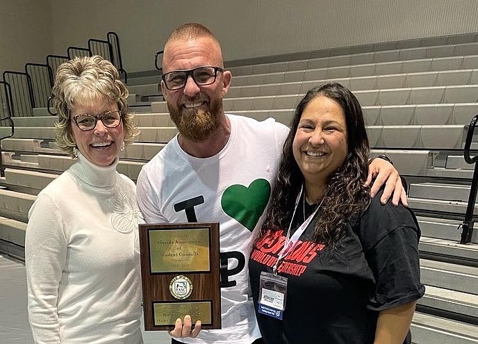 FPC Principal Bobby Bossardet, flanked by FASC Executive Director Melissa Sohn and school SGA advisor Evana Fretterd, displays his Principal of the Year award. Courtesy photo