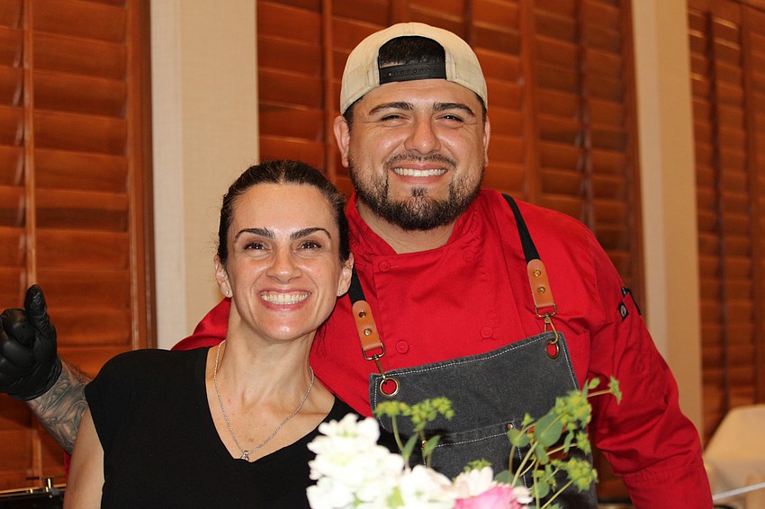 Sebastian Villaseca and Paulina Peralta serve one of the crowd favorites, the crab cakes from the Lazy Lobster.