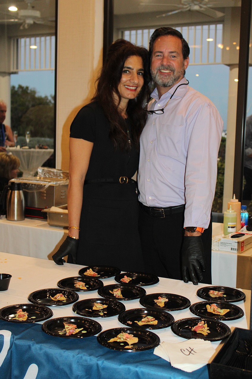Chart House's Anna Ibrahim and Peter Van Beuren keep the table stocked during the busiest point of the evening fundraiser.