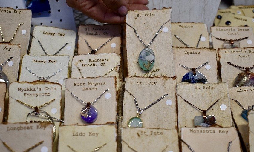 Driftheory's jewelry is made from resin epoxy and incorporates tidbits from each destination into the designs.