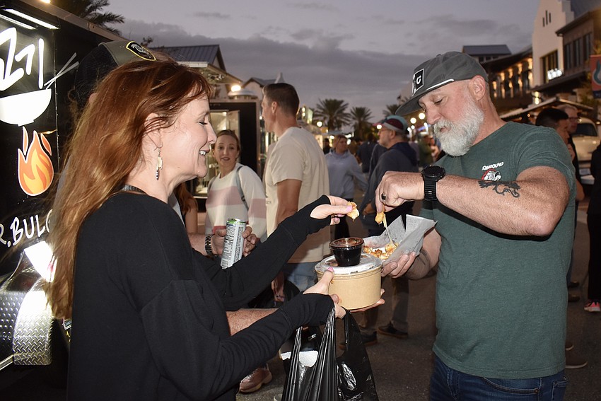Sarasota's Michelle and Josh Wynne pull apart the gooey cheese curds from the Say Cheese Curd Company.