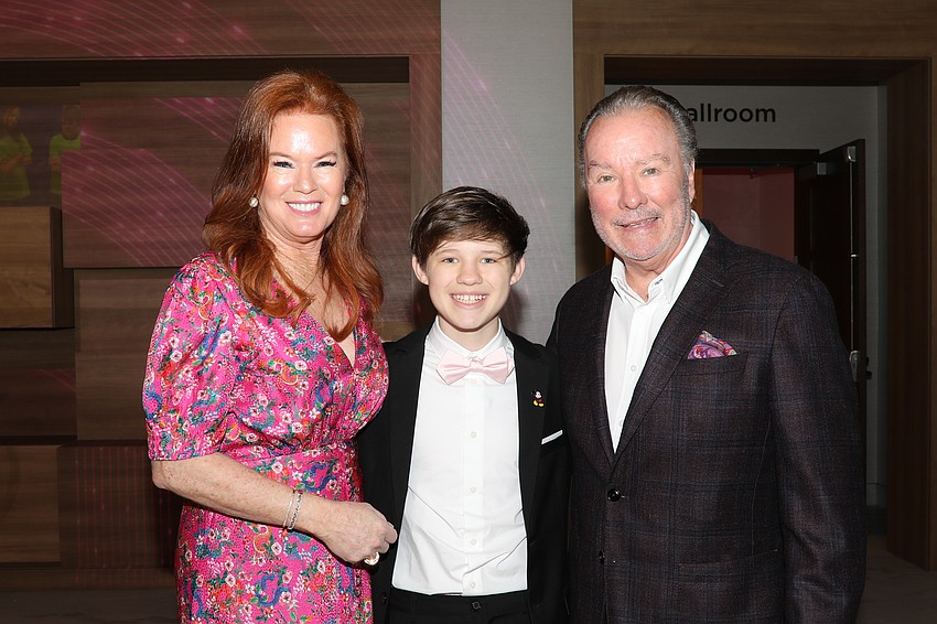 Terri Klauber takes a moment with assistant auctioneer Chance Horvath, 14, who has been assisting Michael Klauber for the past nine years.