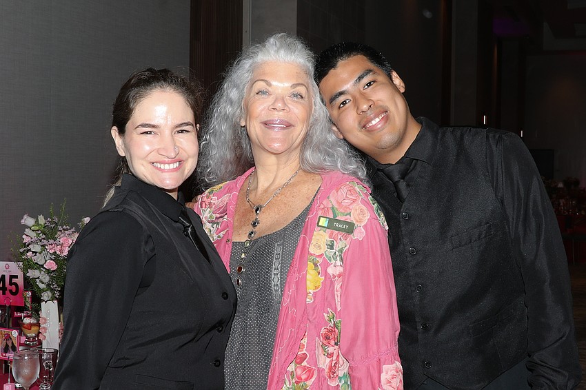 Annasophia Schreber, Tracy McCammack and Miguel Ramos from Michael's On East serve over 500 guests at the Easter Seals luncheon.