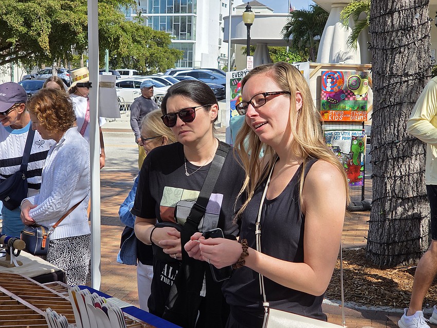 Mary Kortus, left, of Orlando and Ashley Peter of Lexington, Ky. discuss artistic nail files before they were to attend a wedding in Sarasota on Saturday.
