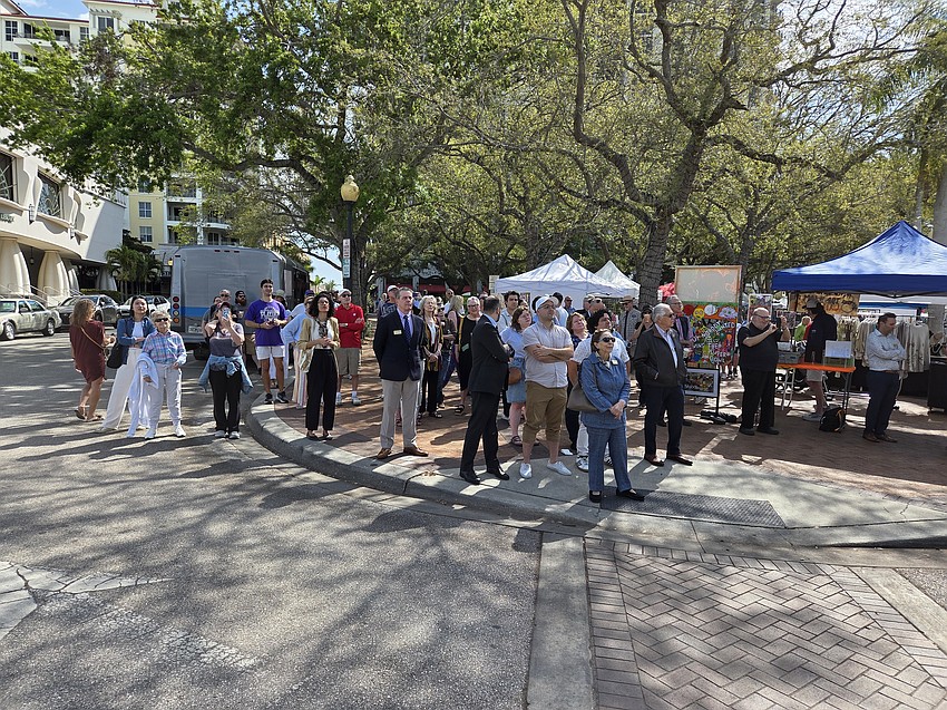 A crowd of Le Marche Marketplace shoppers stopped what they were doing to appreciate the performances from the Sarasota Opera House balcony.