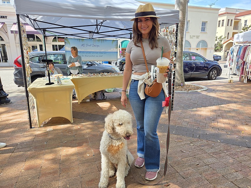 Amber Kuner of Lakewood Ranch enjoys a stroll with her poodle, Mac, at the Le Marche Marketplace.