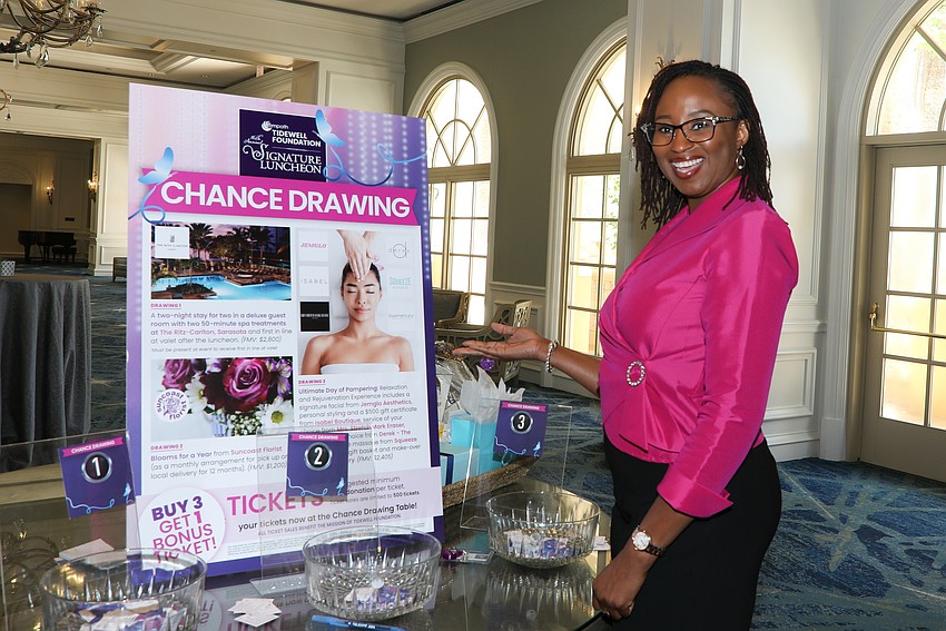 Nafi Cunningham lends a hand at the chance drawing for Empath Tidewell Foundation.