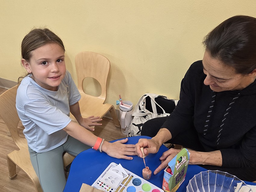 Rose Bryant gets some touching up of nail polish from her mom, Liann Bryant. Liann grew up through Temple Emanu-El and now Rose is following in mom's footsteps.
