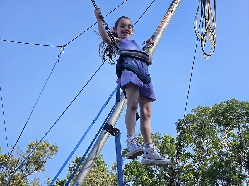 Isabella Franklin is jumping for joy on the trampoline Sunday at the Purim Carnival.