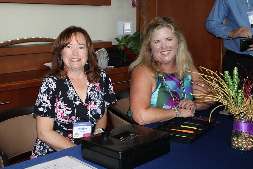 Debbie McPeak and Cathy Goglia vend drink tickets.