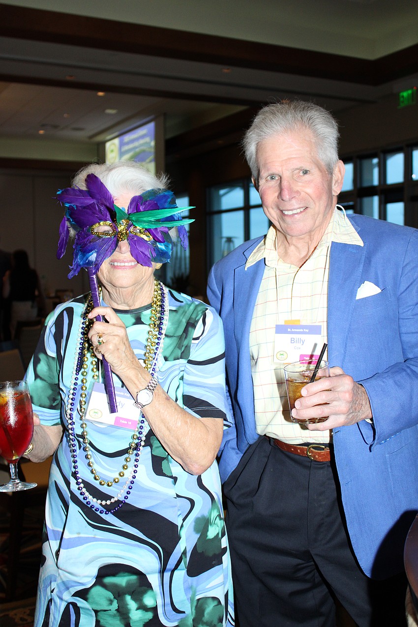 Judy and Billy Cox embrace the Mardi Gras theme.