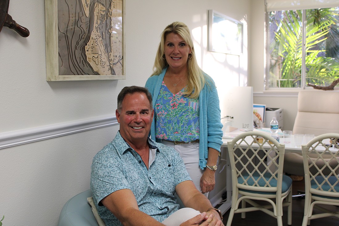 Jim Sauter and Randee Long celebrate the opening of their new real estate and home watch offices.