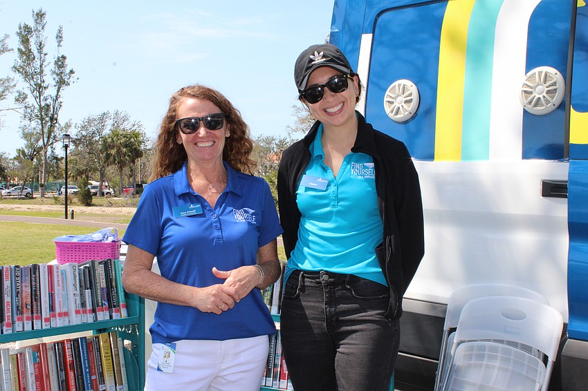 Jessica Gil and Cora Schaeff run the pop-up library at last weekend's open house.