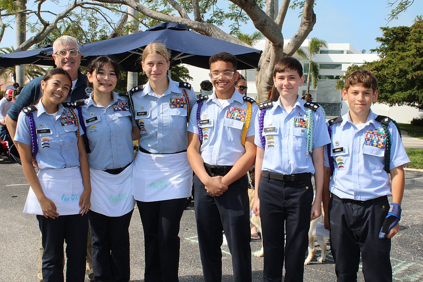 Sarasota Military Academy Prep volunteers Emily Huynh, Kamilah Barros, Lucy Dispenza, Dylan Cruz Carbonell, Thaddeo Knipfer and Anthony Ramirez accompany Militar Studies Instructor Captain Bill Edwards to help out with the dog parade.