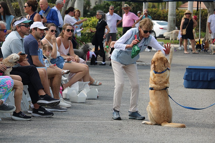 Sandy takes a detour off stage to demonstrate her trick with Janet Stanard.