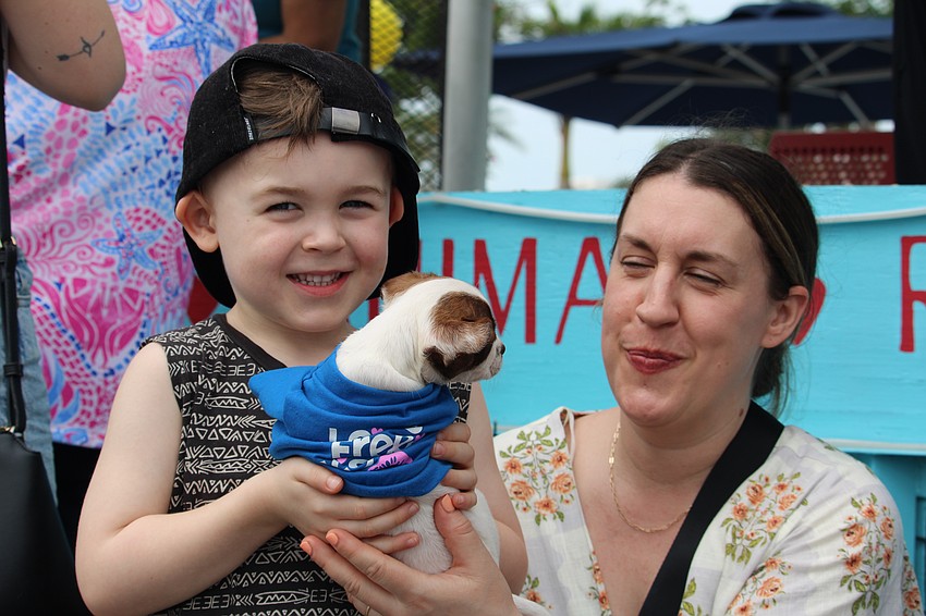 Bowie Limoges, 5, of Ottawa carefully holds one of the puppies at the dog parade.