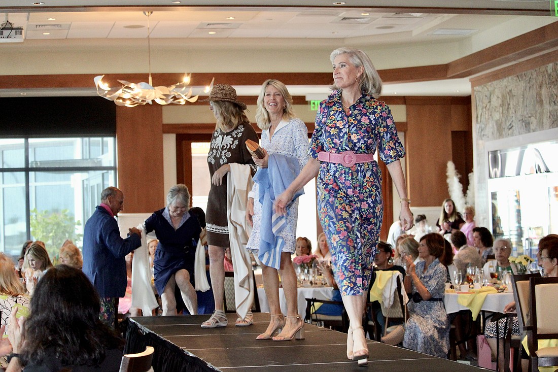 Led by Danielle Gladding, the models of this year's St. Mary, Star of the Sea, Catholic Church take a last lap on the catwalk at Sarasota Yacht Club.