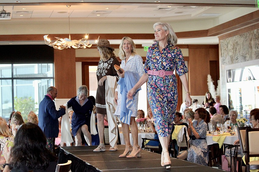 Led by Danielle Gladding, the models of this year's St. Mary, Star of the Sea, Catholic Church take a last lap on the catwalk at Sarasota Yacht Club.