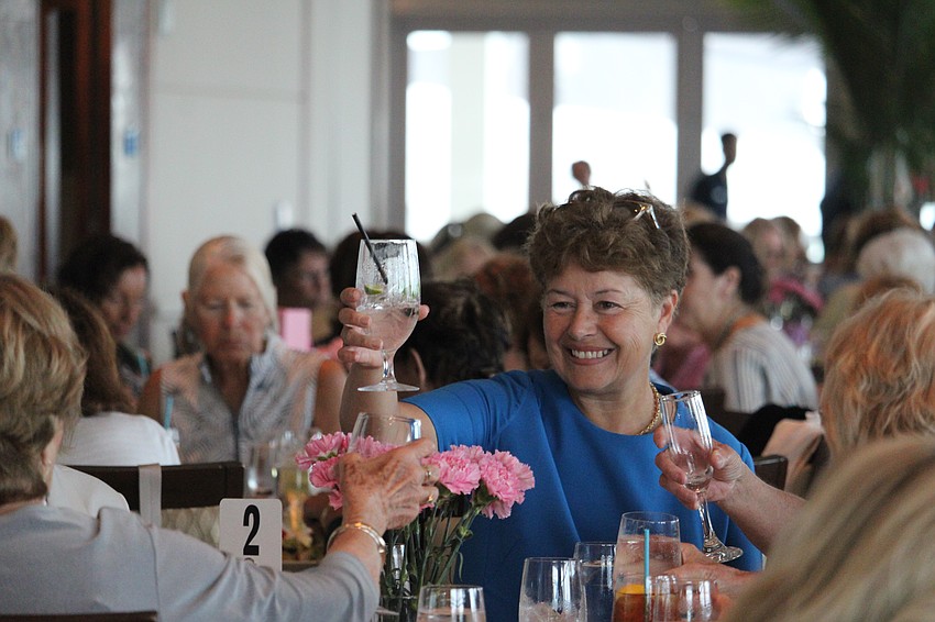 Catherine Diao gives a cheers with her friends at the fashion show.