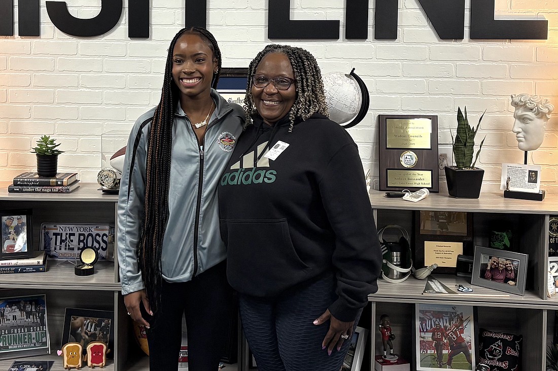 Karina Marcelus (left) with Debra McCaskell. Marcelus broke McCaskell's 1980 school record in the 100 hurdles at the North Florida/South Florida Challenge on March 8. Courtesy photo