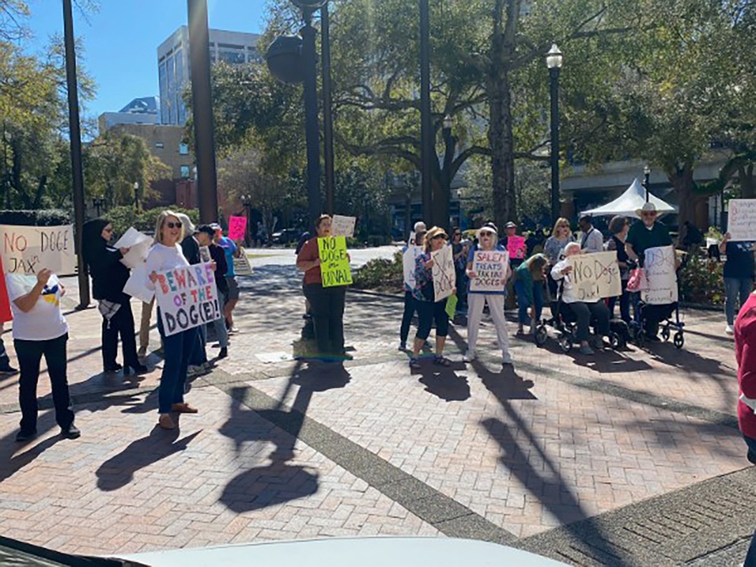 Citizens protest plans to start a Jacksonville version of the Trump Administration's Department of Government Efficiency before a meeting at City Hall on March 11.